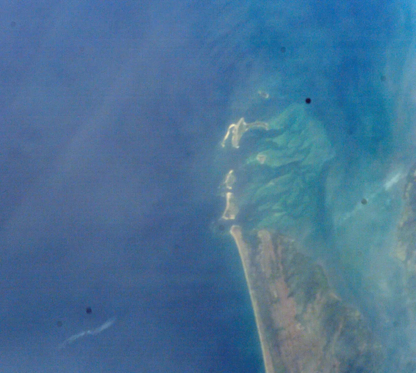 Sandbars and turquoise shallows along the coast of Sierra Leone, photographed from the Space Shuttle